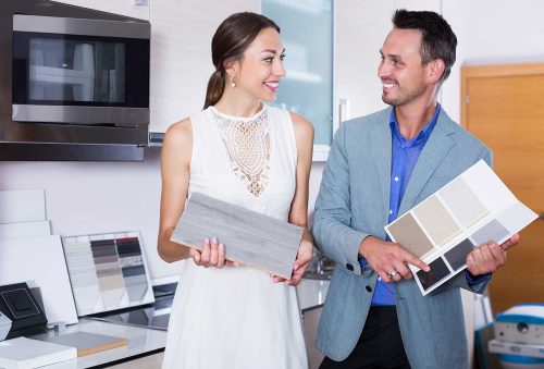 Couple choosing kitchen fronts materials Happy couple choosing kitchen fronts materials for their apartment